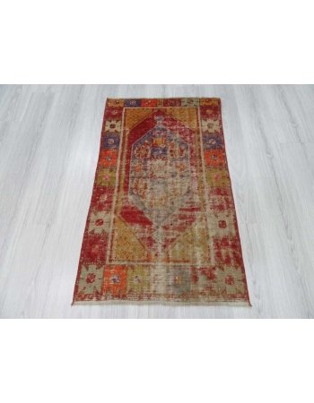 Vintage distressed colorful small Turkish rug