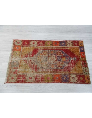 Vintage distressed colorful small Turkish rug