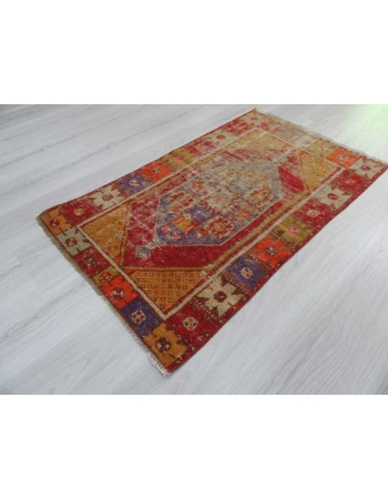 Vintage distressed colorful small Turkish rug