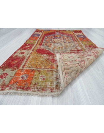 Vintage distressed colorful small Turkish rug